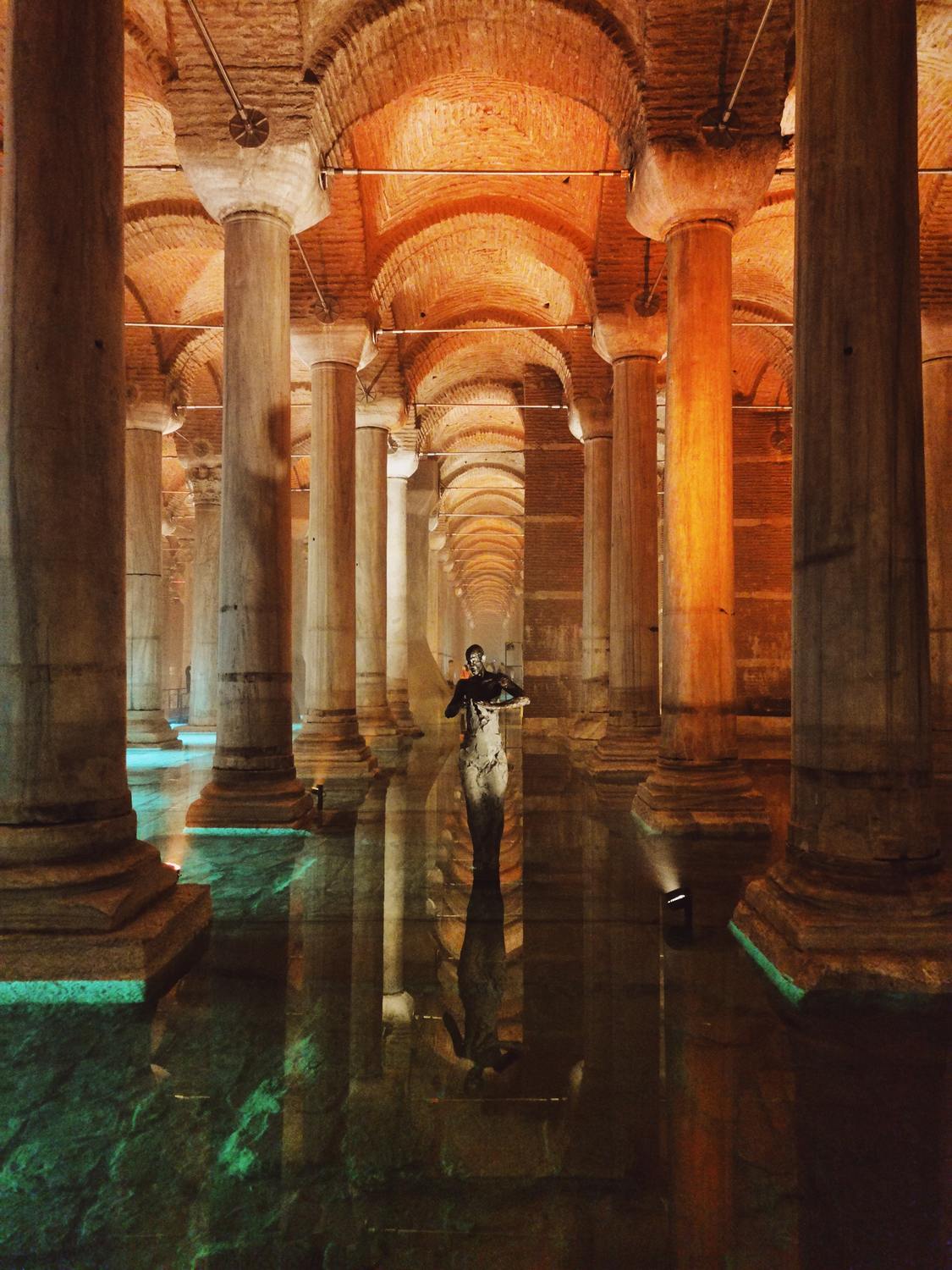 Statue of a man in the middle of the Basilica Cistern